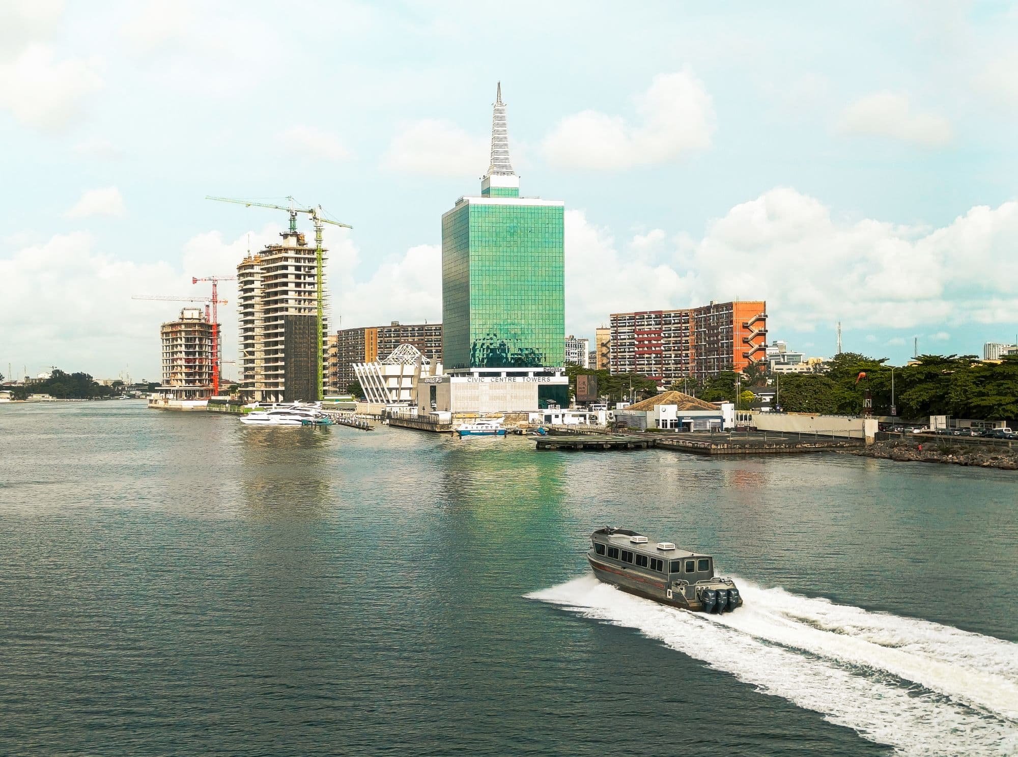 The Lagos skyline across the lagoon, a boat crossing in front